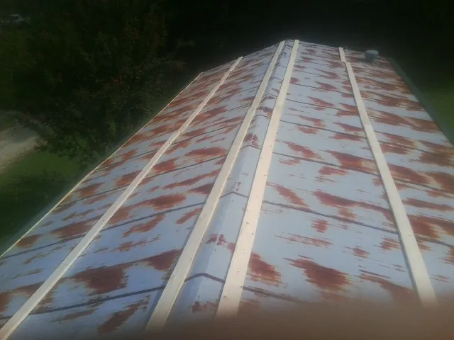 Rusted metal roof panels with new wood purlins before replacement — Storm Damage Roof Repair in Julian by Roofing Brothers