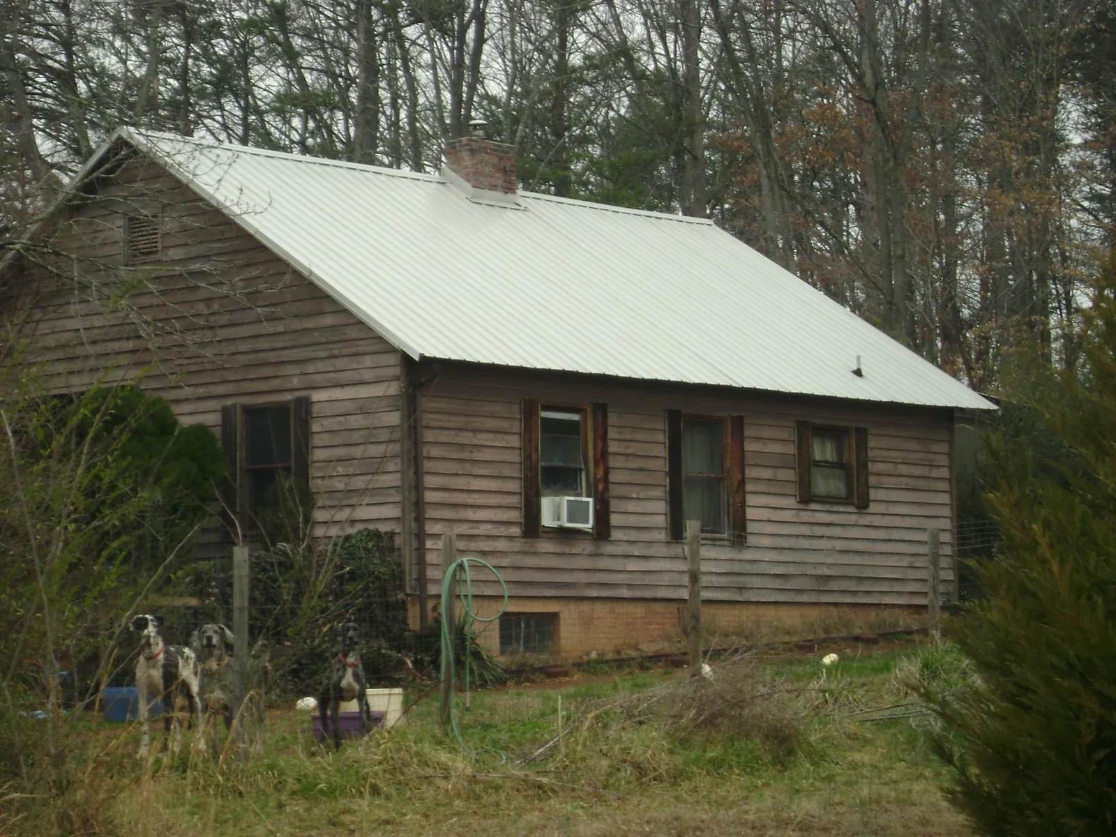 White metal roof on an old wood sided farmhouse, from a Metal Roof Installation job in Julian